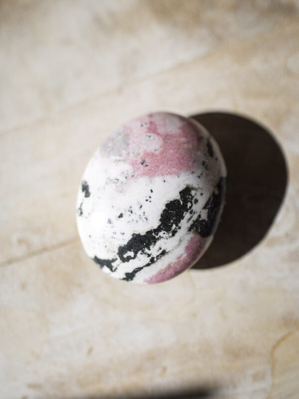 Rhodochrosit palmstone i håndpoleret kvalitet - lyserød krystal med naturlige bånd, ideel til selvkærlighed, healing og meditation.